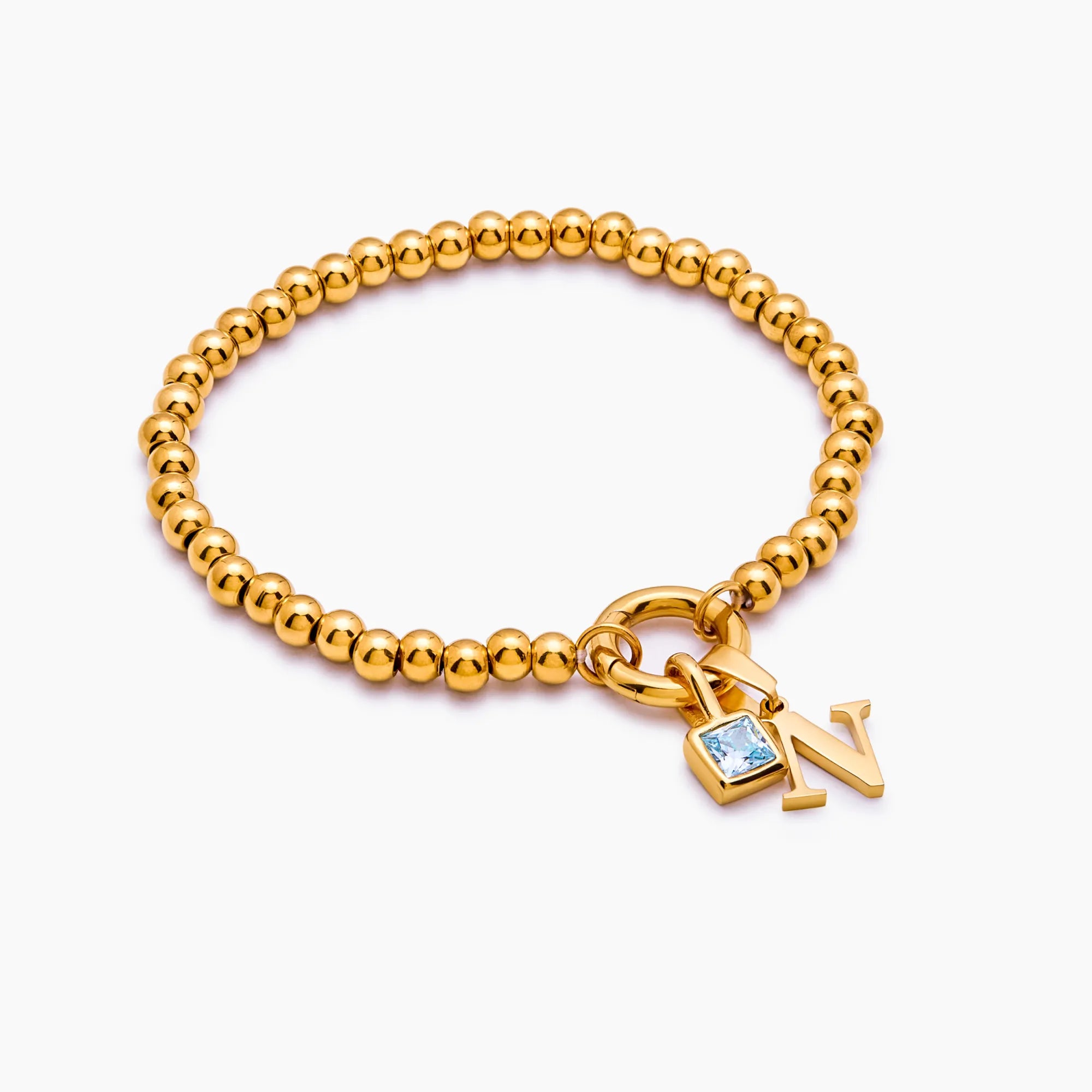 Beaded initial birthstone bracelet flat lay — Olivia Jewelry