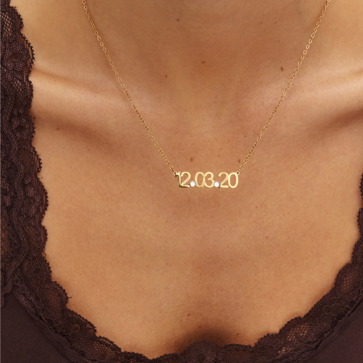 Close-up of Custom Date Necklace in gold on the collarbone