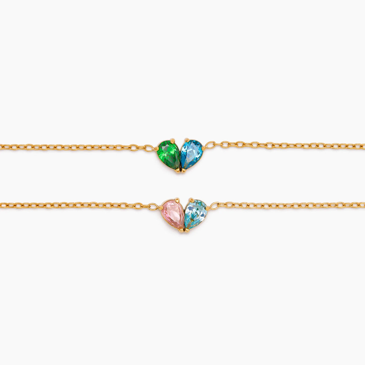Close-up of two Duo Heart Bracelets with different birthstone pairs