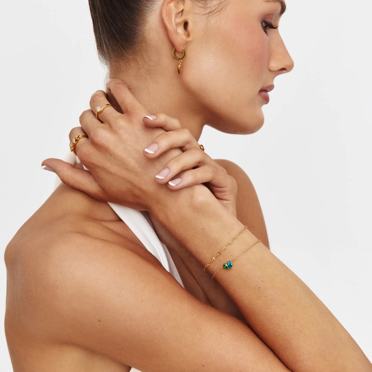 Model wearing the Duo Heart Bracelet with hands at the neck